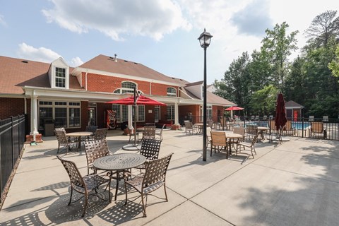 a patio with tables and chairs outside of a building