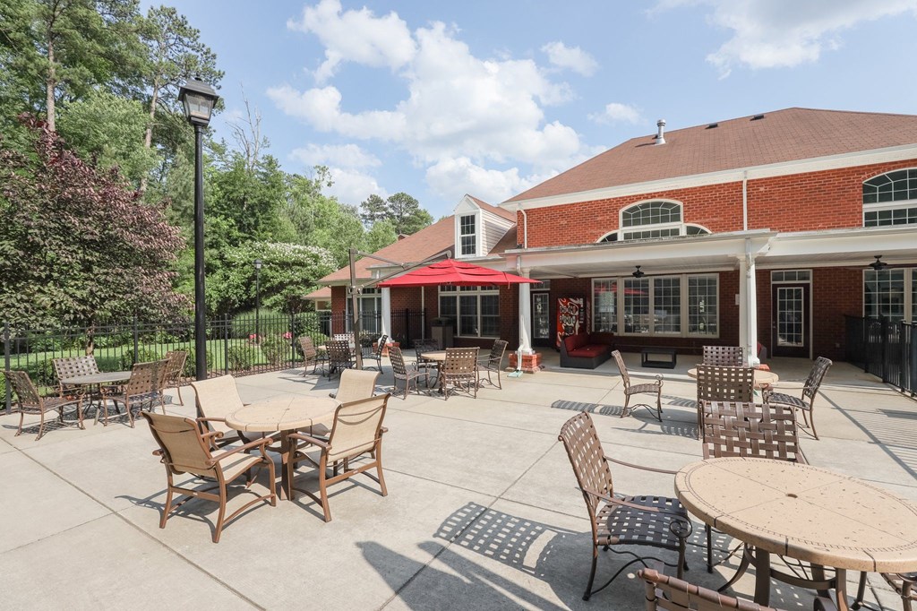 a patio with tables and chairs outside of a building