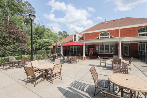 a patio with tables and chairs outside of a building