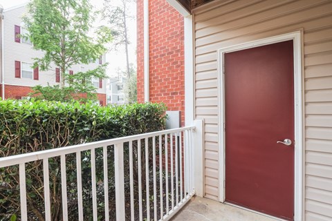 the entrance to a house with a red door