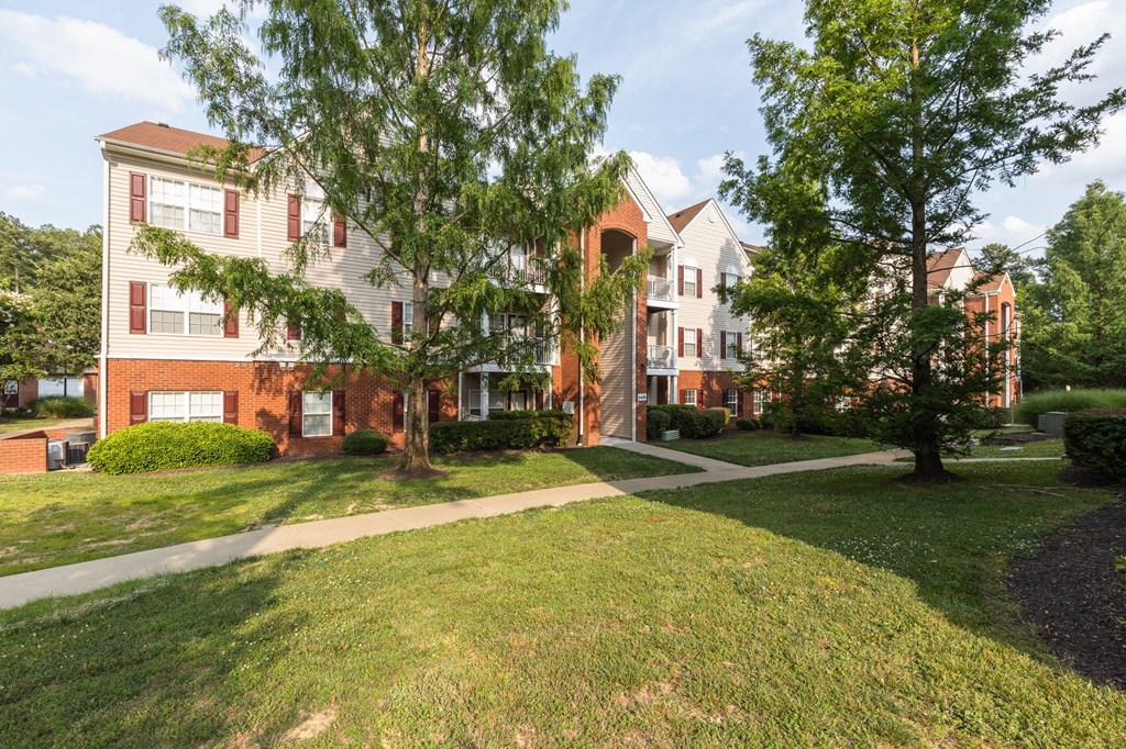 our apartments are located in a quiet neighborhood with green grass and trees
