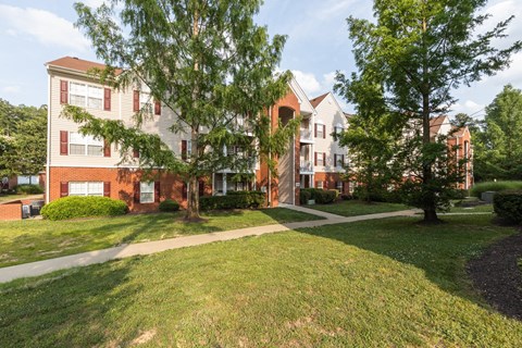 our apartments are located in a quiet neighborhood with green grass and trees