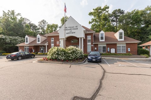 the front entrance of the huntsman memorial hospital with cars parked in front of it