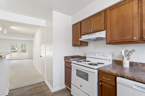 a kitchen with white appliances and wooden cabinets