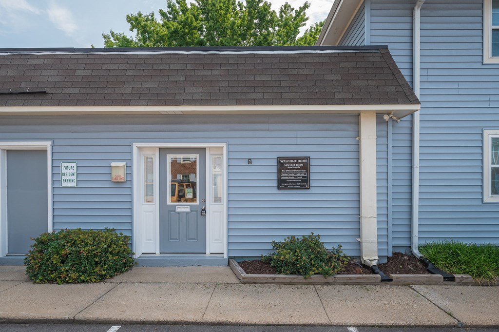 the front of a blue building with a blue door