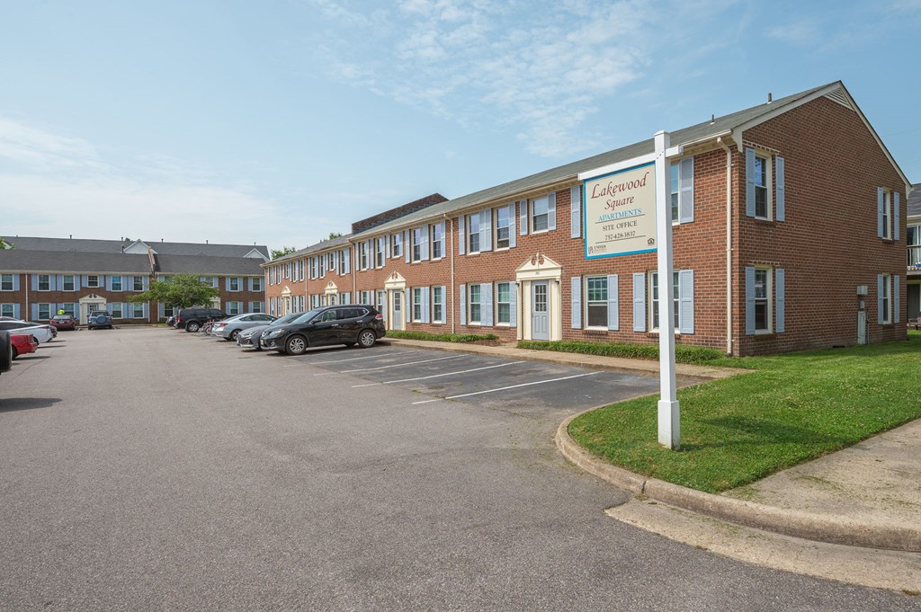 a parking lot in front of a brick building