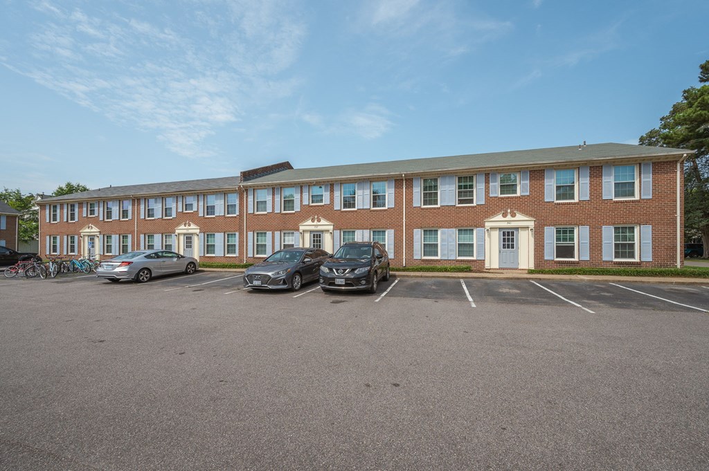 a large brick building with cars parked in front of it