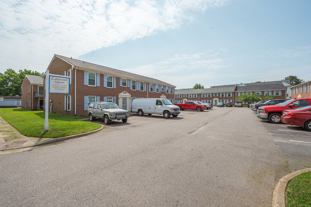 a city street with cars parked in front of a building