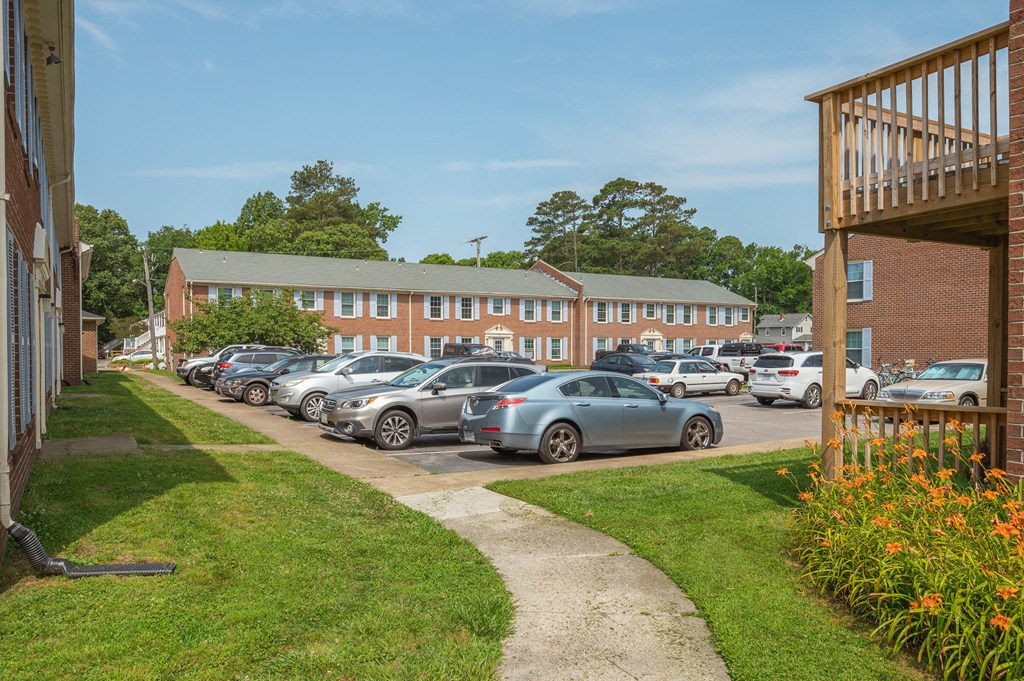 a parking lot filled with cars in front of a building