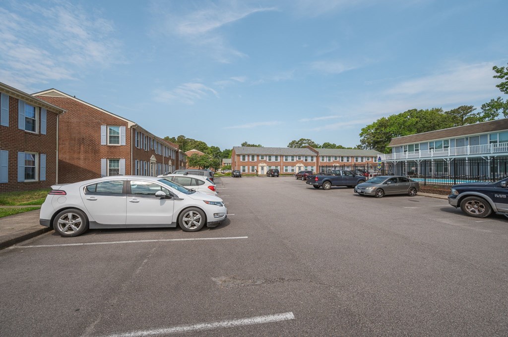 a parking lot with cars in front of a building