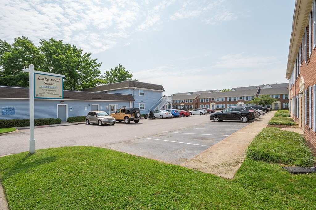 a parking lot with cars in front of a building