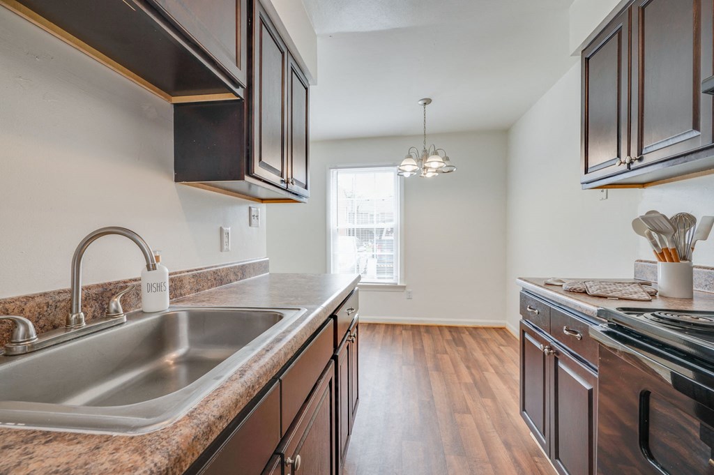 an empty kitchen with a sink and a window