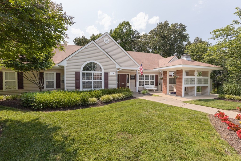 a house with a lawn and a flag in front of it