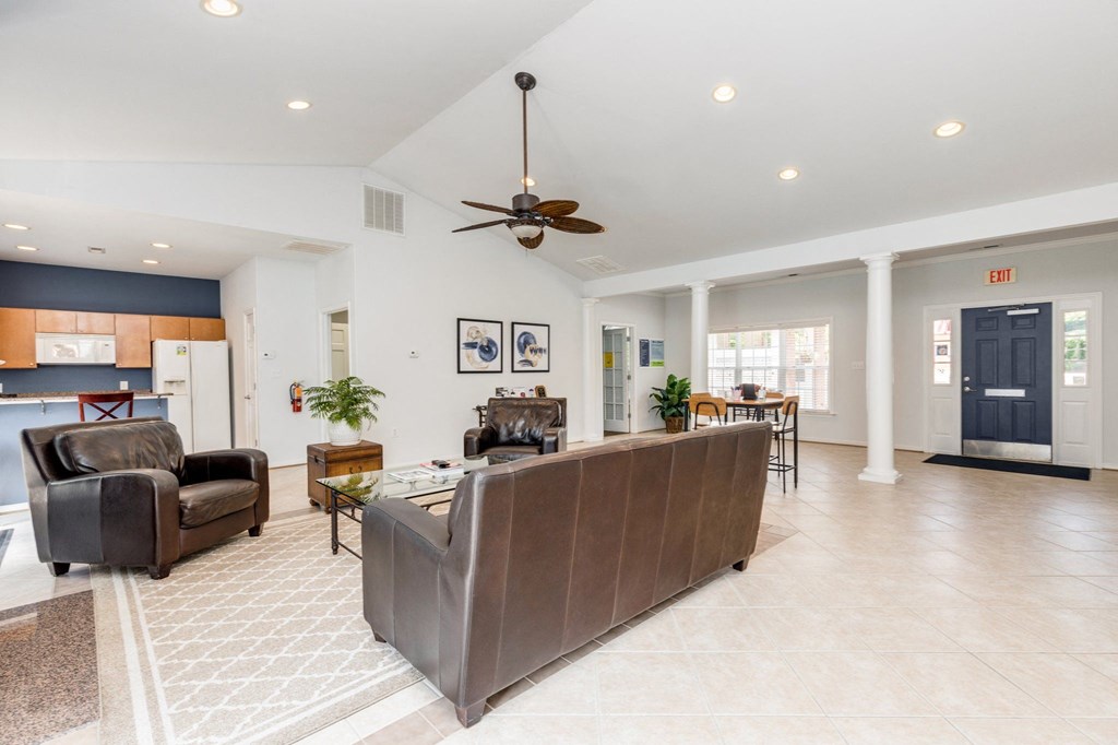 a living room with a couch and a ceiling fan