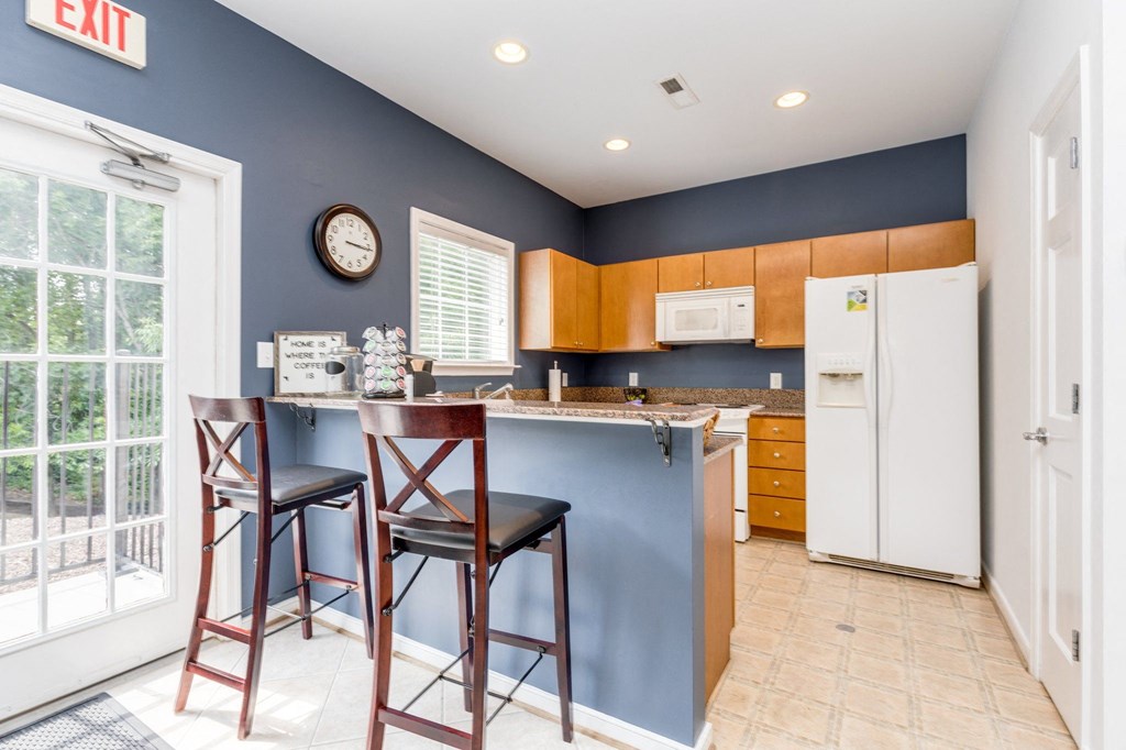 a kitchen with a breakfast bar and two stools