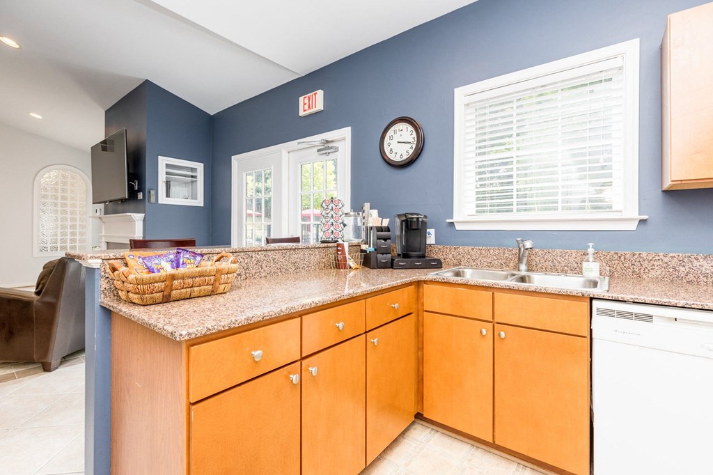 a kitchen with blue walls and a counter top with a sink