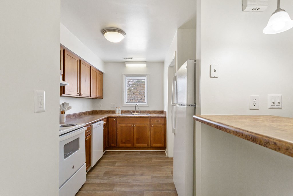a kitchen with white appliances and wooden cabinets