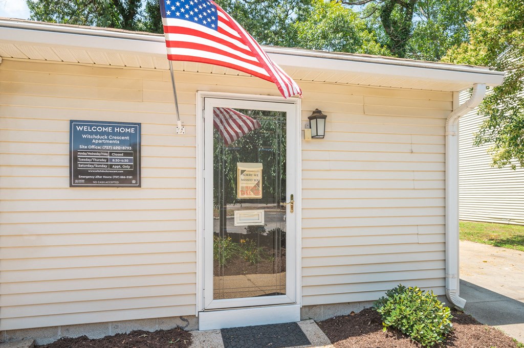 the front door of the welcome center with an flag