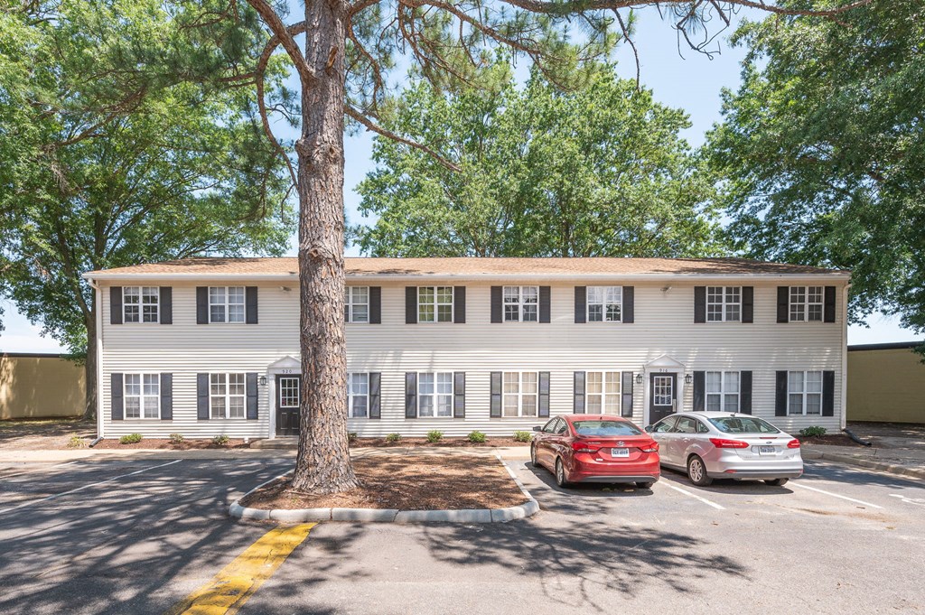 a large white building with cars parked in front of it