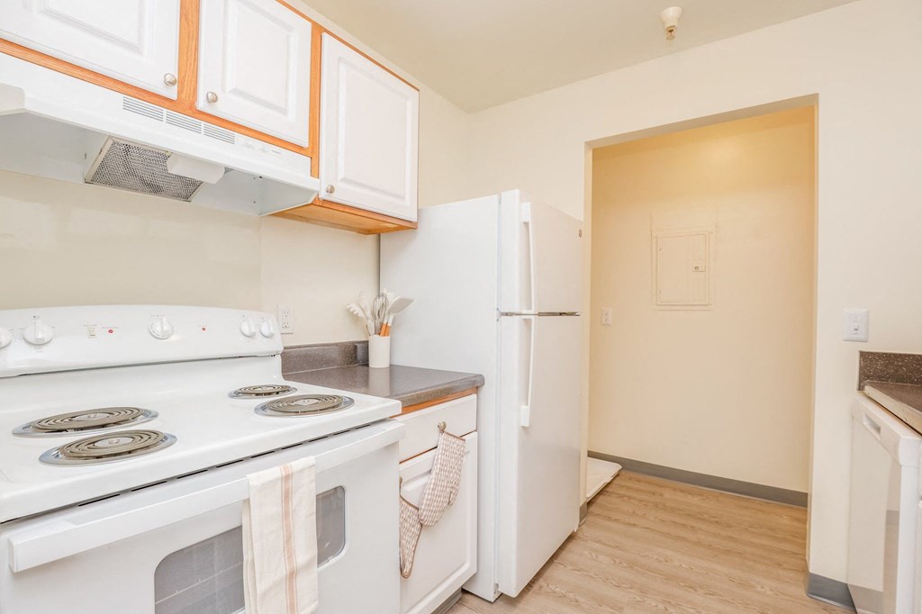 a kitchen with white appliances and a white refrigerator