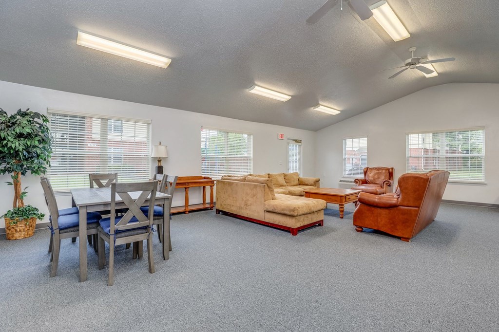 a living room with couches and chairs and a dining table