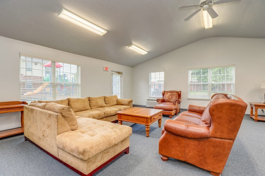 a living room with couches and chairs and a coffee table