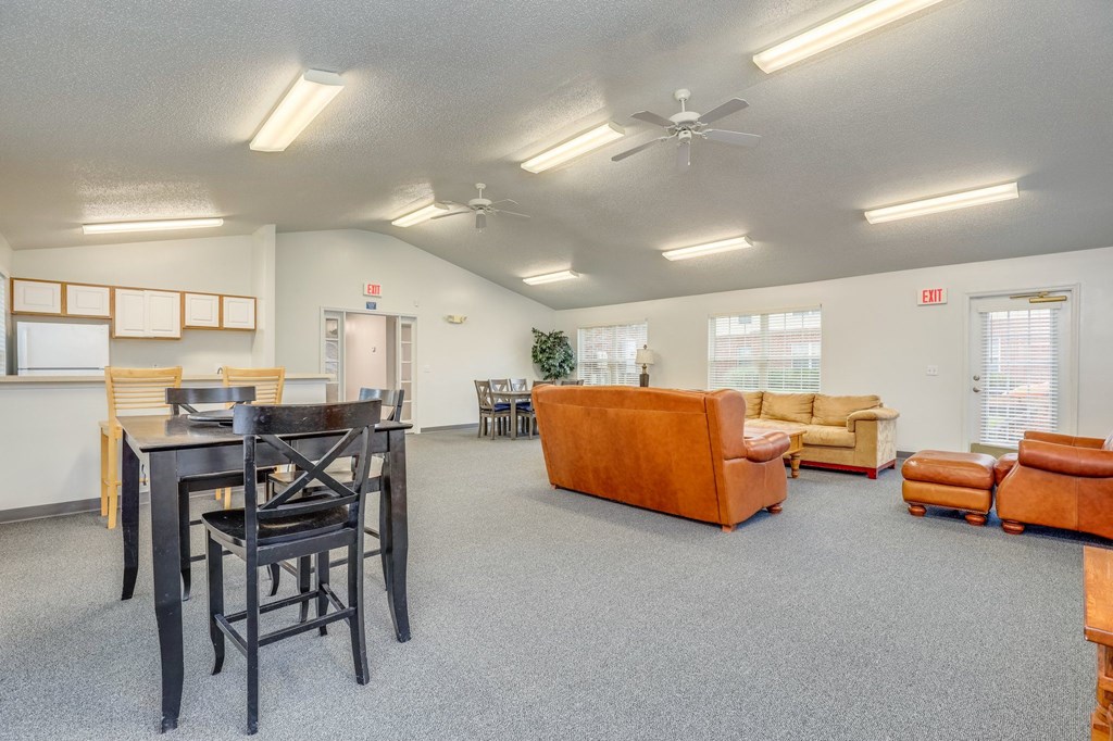 a living room with couches and chairs and a dining table