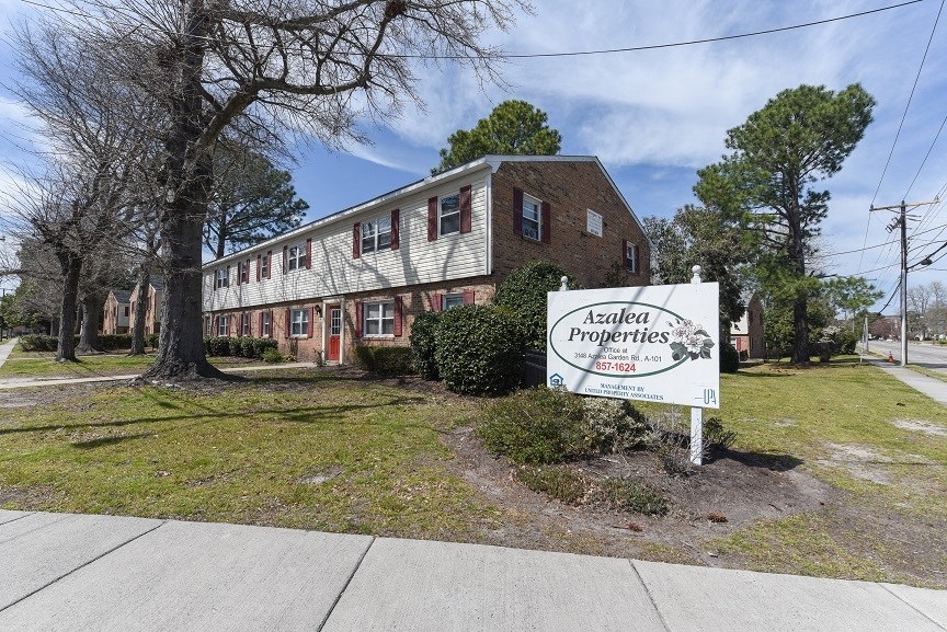 a large brick building with a sign in front of it