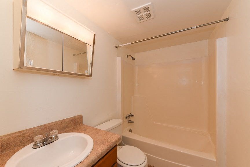 a bathroom with a sink toilet and a shower