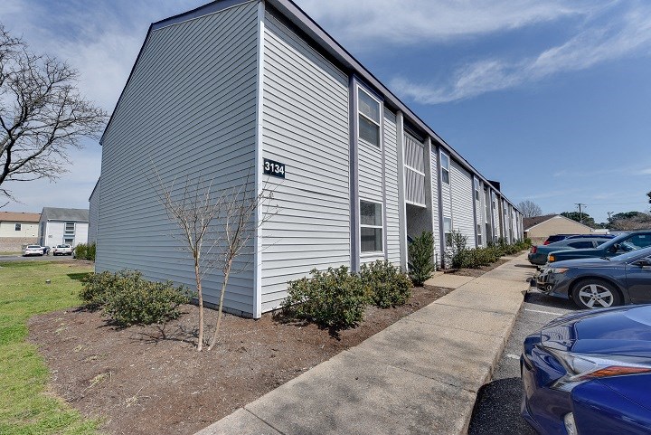 a white building with cars parked in front of it