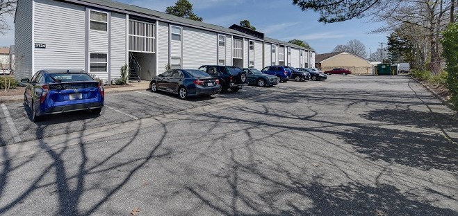 a parking lot with cars in front of a building