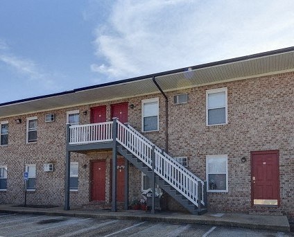 a brick building with a balcony and a staircase