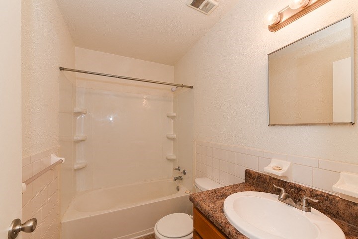 a bathroom with a sink and a shower and a toilet