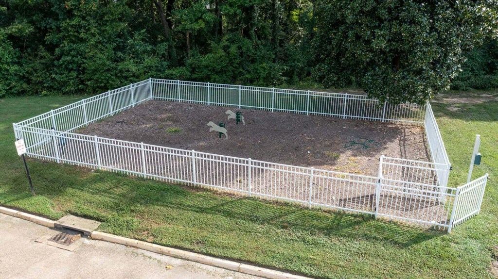 a fenced in backyard with chickens in it