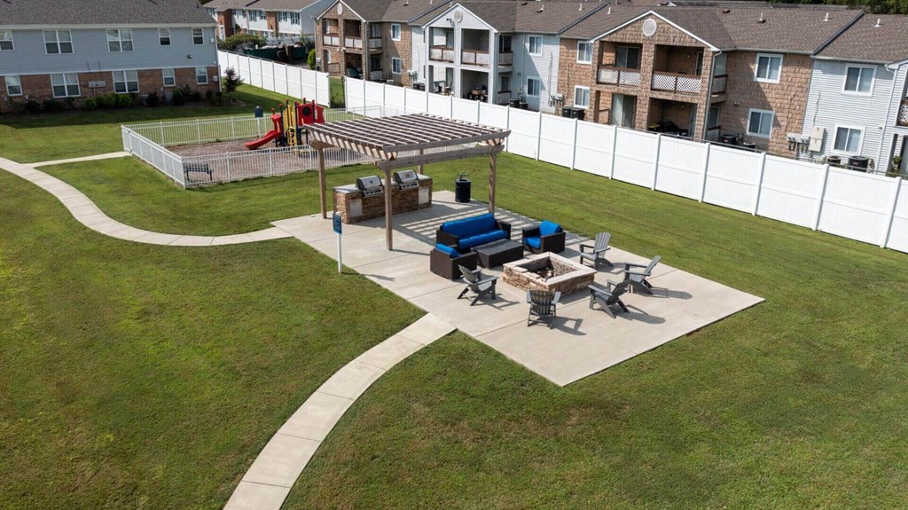 a picnic area in the backyard of an apartment complex