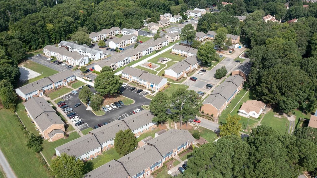 an aerial view of a neighborhood with houses and parking lot