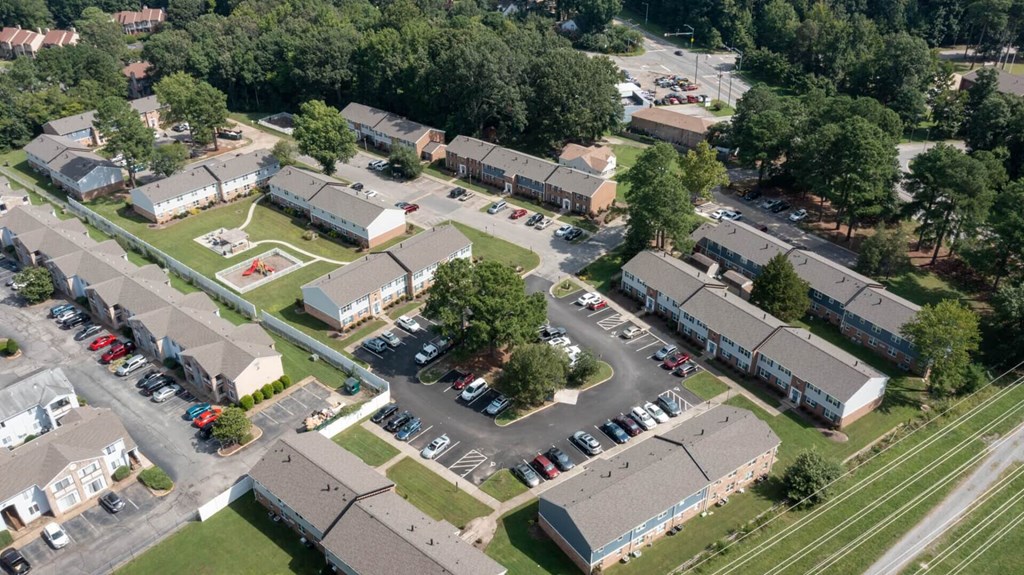 an aerial view of a neighborhood of houses with cars parked