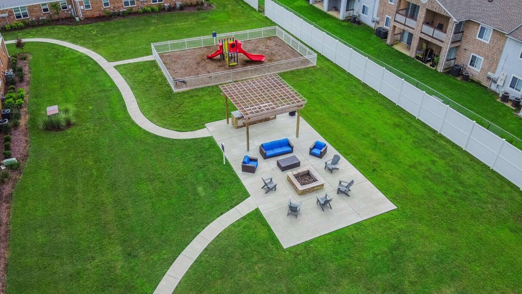 an aerial view of the playground in the yard of an apartment building