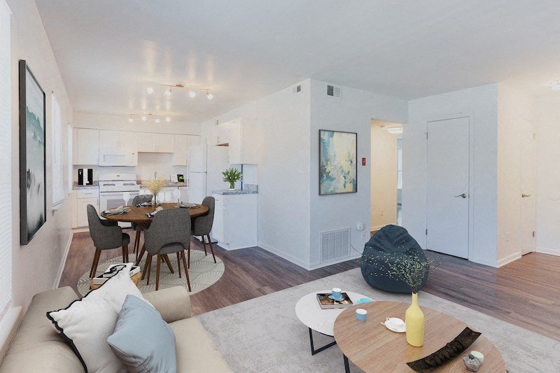 a living room with a couch and a table and a kitchen