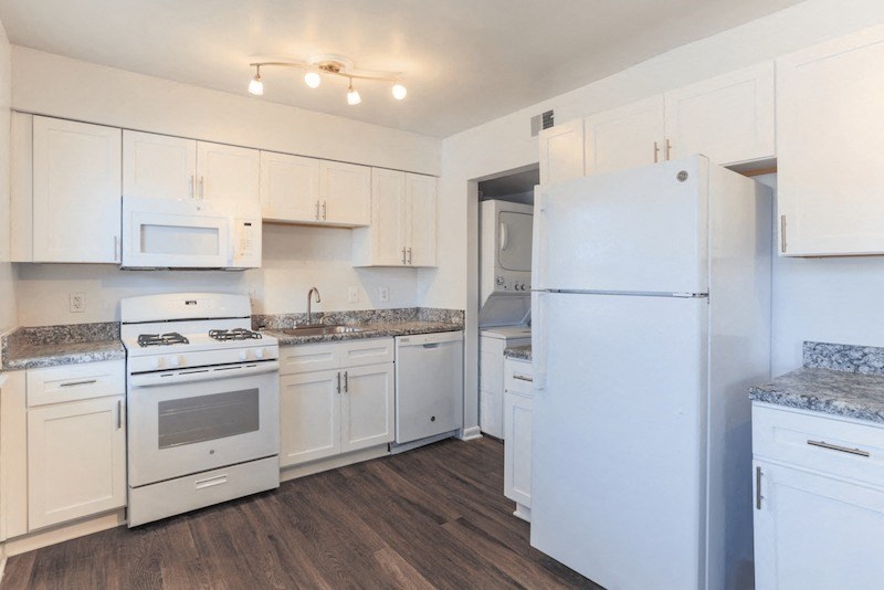 a white kitchen with white appliances and white cabinets