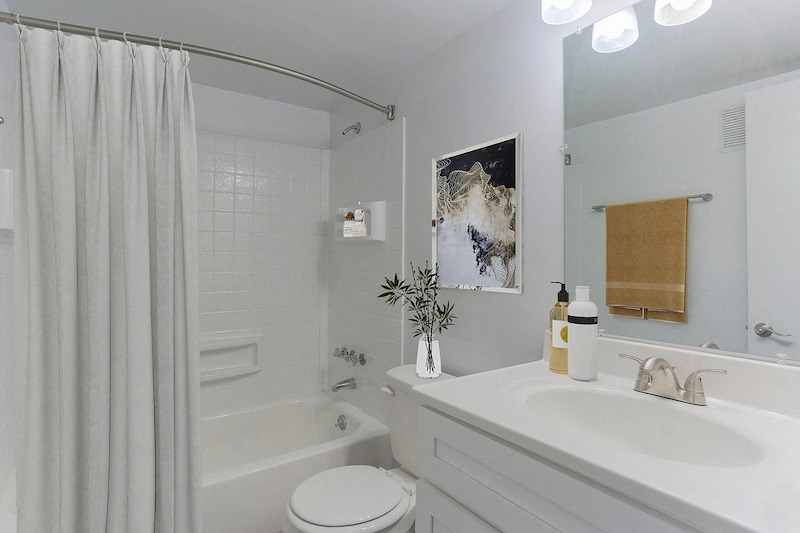 a bathroom with a sink toilet and a bath tub