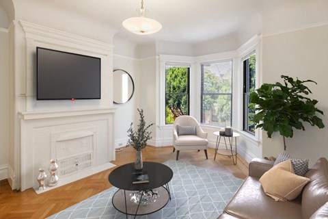 a living room with a fireplace and a tv on the wall