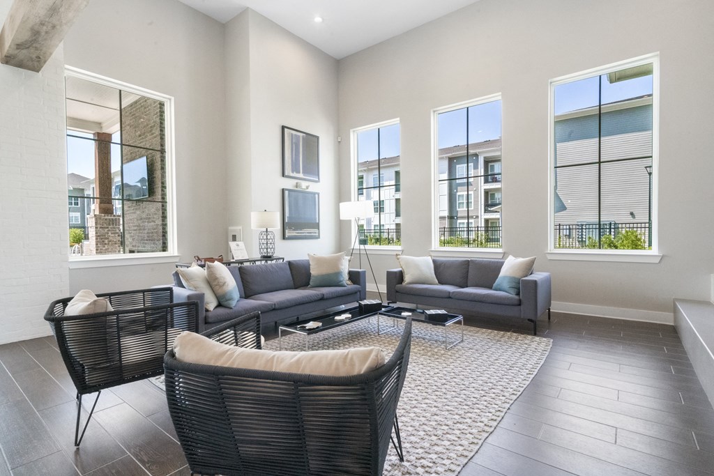 a living room with couches and chairs and a rug