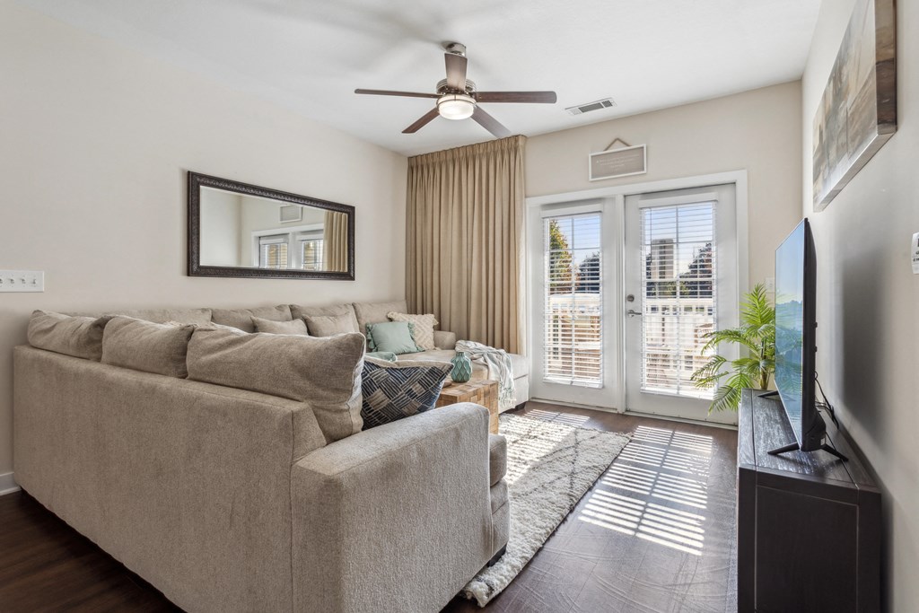 a living room with a couch and a ceiling fan at Hampton Roads Crossing, Virginia