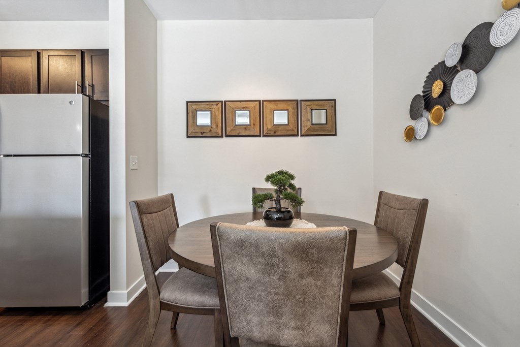 a dining room with a table and chairs and a refrigerator a dining room with a table and chairs and a refrigerator at Hampton Roads Crossing, Suffolk, 23435