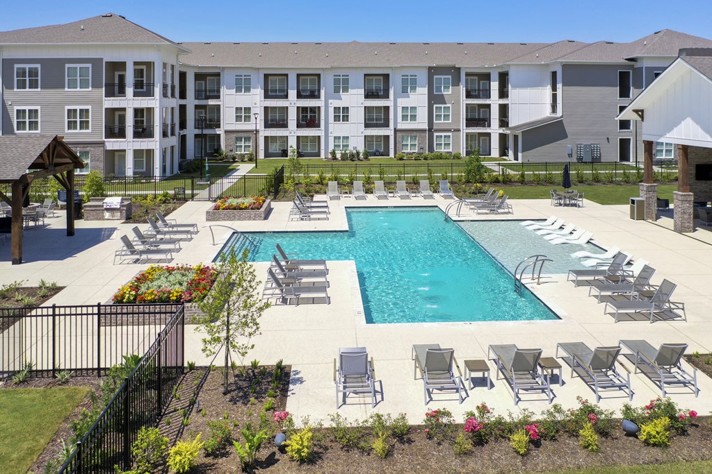 an aerial view of an apartment complex with a swimming pool
