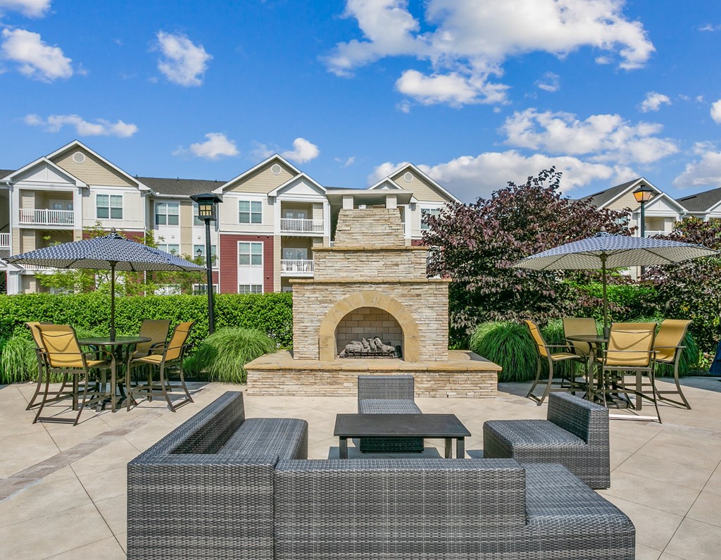 Soft seating with umbrellas and fireplace at Hampton Roads Crossing, Suffolk, VA