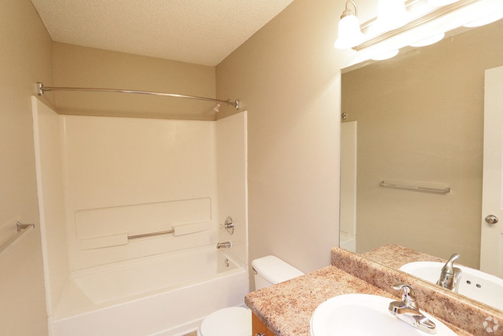 a bathroom with a sink and a shower and a toilet