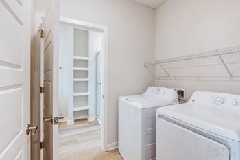 A white laundry room with a washer and dryer.