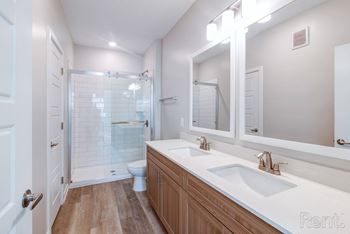 A bathroom with a white sink and a white toilet.